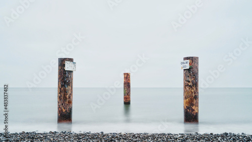 Holzpfähle im Wasser am Strand