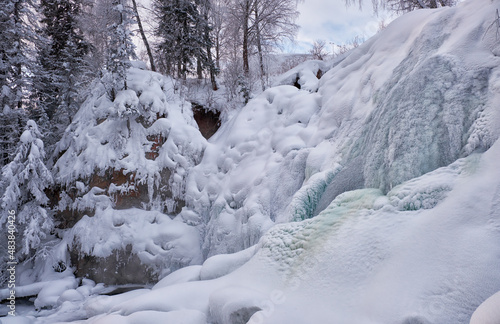 Photo of frozen waterfall on river Pescherka in winter. Siberia, Russia