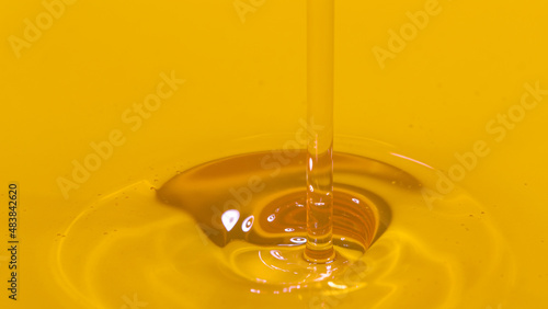 MACRO: Cinematic shot of unrefined walnut oil getting poured into a container.