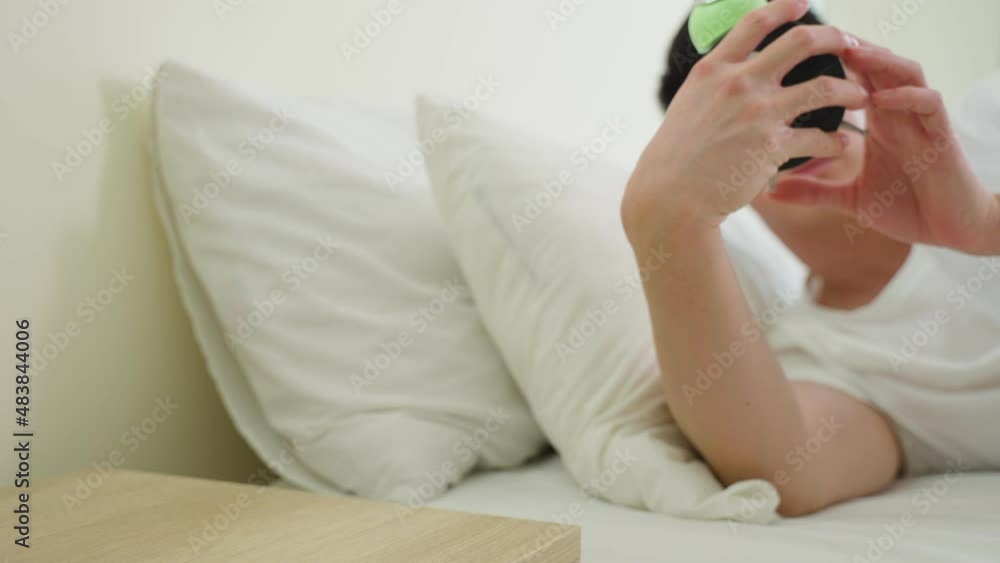 Asian attractive young man turn off alarm clock ringing in the morning. Asian attractive young man turn off alarm clock ringing in the morning.