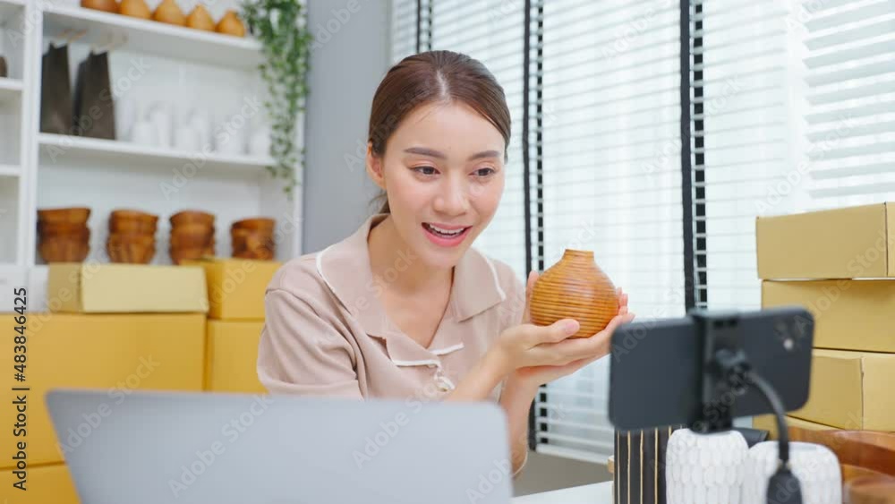 Asian beautiful woman sell vase product online live streaming at home. Asian beautiful woman sell vase product online live streaming at home.
