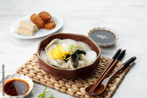 Manduguk Korean Dumpling Soup, Mandu and Clear Broth with Nori, Egg, and Spring Onion Topping. photo