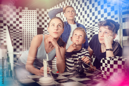 Canvas Print Two thoughtful teen boys with their parents trying to find solution of conundrum