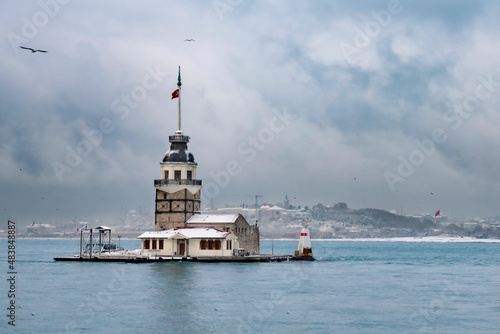 Magnific view of Maiden's Tower (aka Kiz kulesi) in winter day with many snow in Istanbul,Turkey. Istanbul's main attractions.  photo
