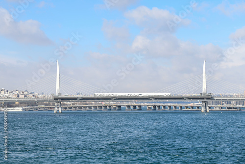 Panoramic view of Golden Horn Metro Bridge during cold winter day with many snow. Istanbul. Turkey.