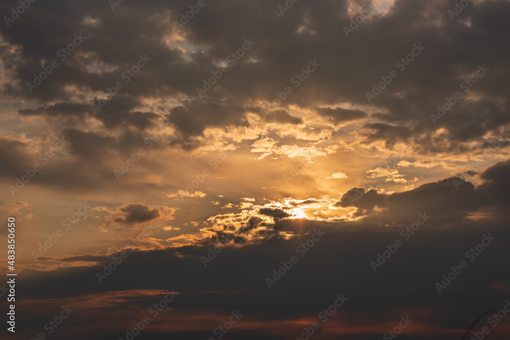Dramatic Sunset Sky with Dark Clouds and Golden Rays