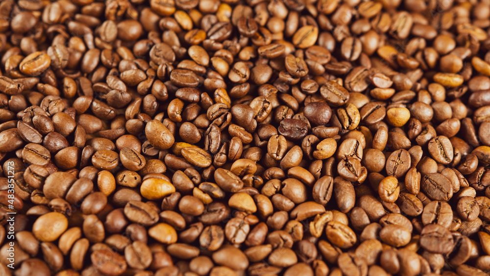 Texture of freshly coffee beans. Lots of roasted beans for preparation of fragrant drink. Close up. Texture of freshly coffee beans. Lots of roasted beans for preparation of fragrant drink. Close up.