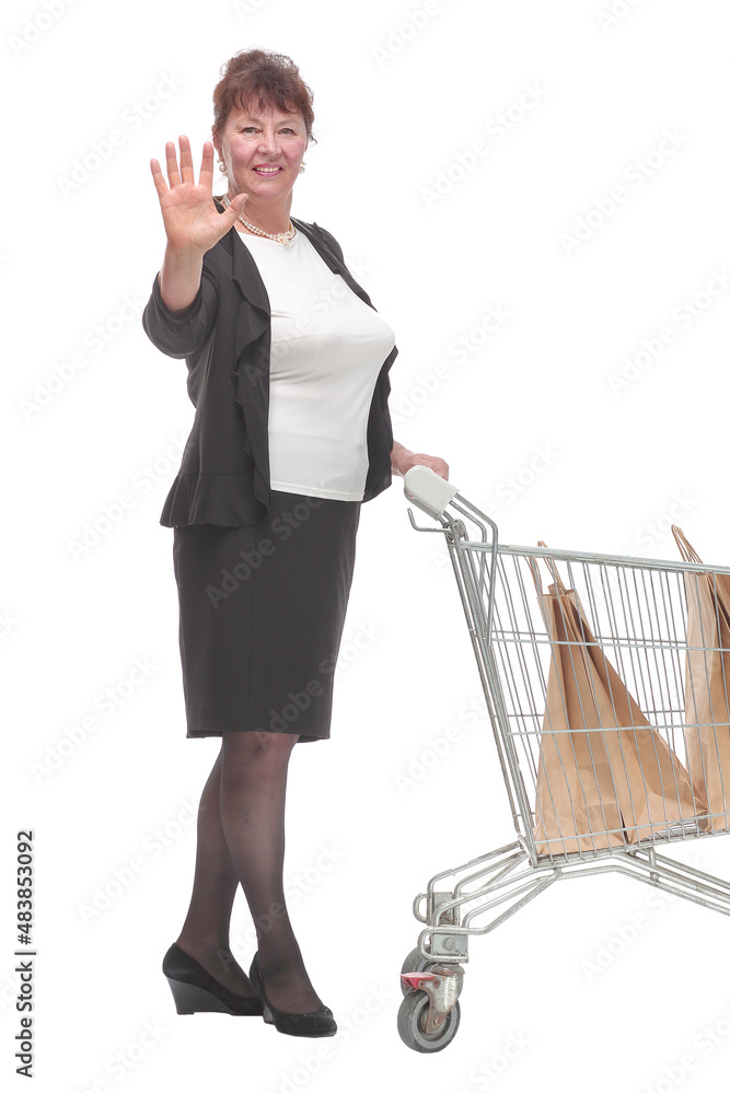 Full length portrait of a woman pushing a shopping trolley Full length portrait of a woman pushing a shopping trolley