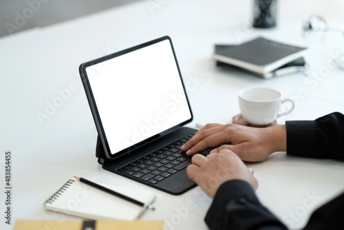 Young man working on his laptop with blank copy space screen for your advertising text message in office, Back view of business man hands busy using laptop at office desk