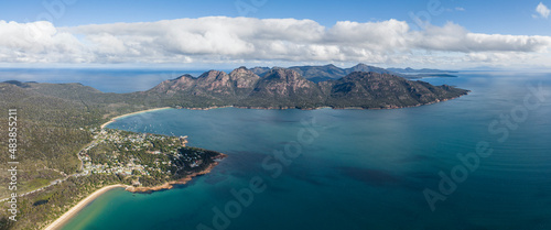 XXL panoramic high angle aerial drone view of Coles Bay with Richardsons Beach and Hazards mountain range, part of Freycinet Peninsula National Park, Tasmania, Australia. Muirs Beach in foreground
