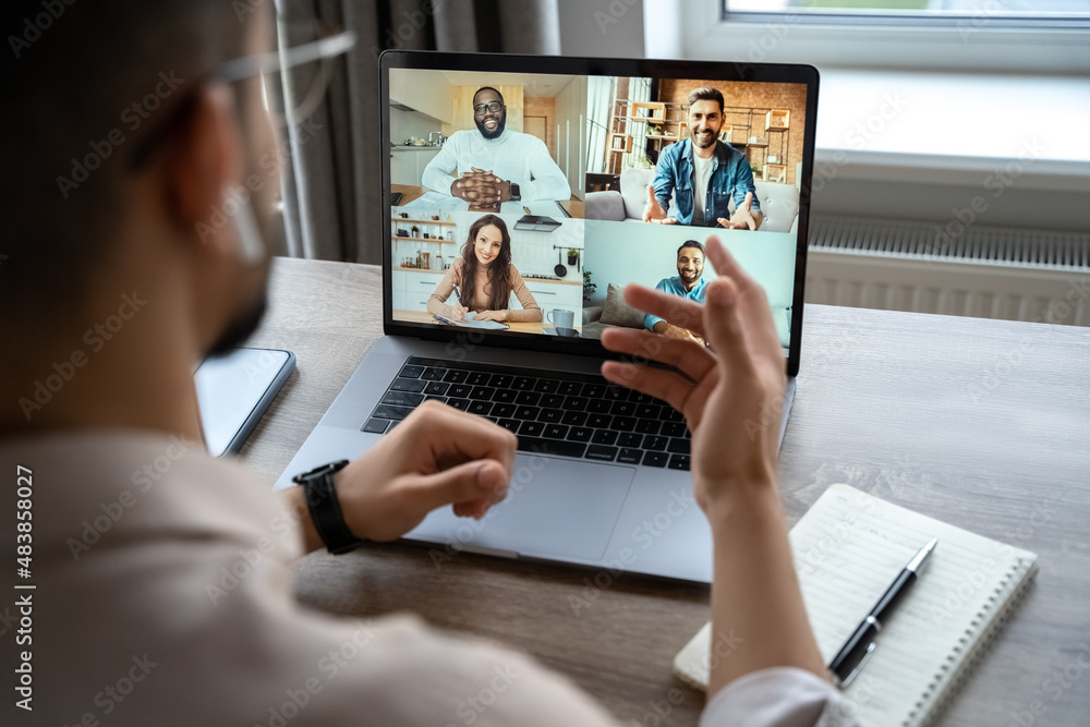 Back view of man having virtual training on video call meeting, online webinar Back view of man having virtual training on video call meeting, online webinar