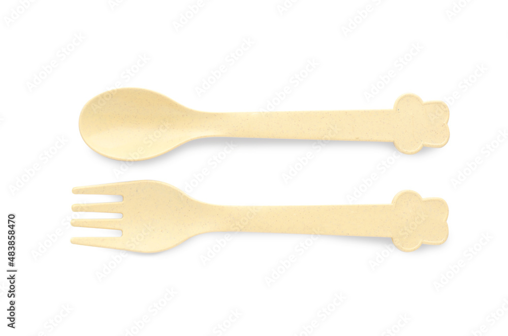 Plastic cutlery on white background, top view. Serving baby food Plastic cutlery on white background, top view. Serving baby food