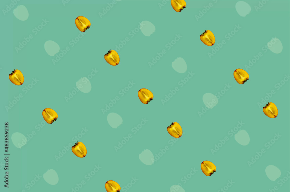 Colorful fruit pattern of fresh persimmons on green background. Top view. Flat lay. Pop art design Colorful fruit pattern of fresh persimmons on green background. Top view. Flat lay. Pop art design