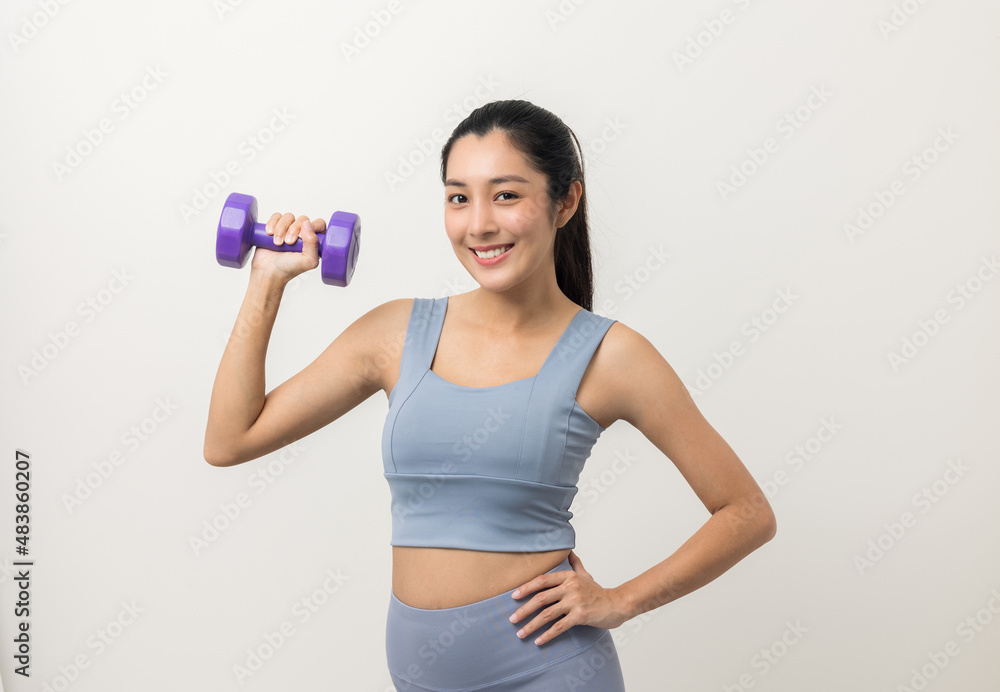 Sporty Asian woman exercises with dumbbells on isolated white background. Good shape and health fitness woman weight training standing pose smile to camera. Sporty Asian woman exercises with dumbbells on isolated white background. Good shape and health fitness woman weight training standing pose smile to camera.