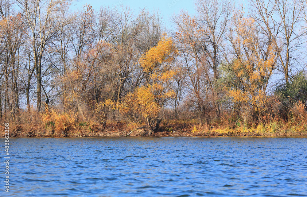 A natural blurred landscape of the river in autumn. Astrakhan Region, Russia. Defocused.River sand beach. A natural blurred landscape of the river in autumn. Astrakhan Region, Russia. Defocused.River sand beach.
