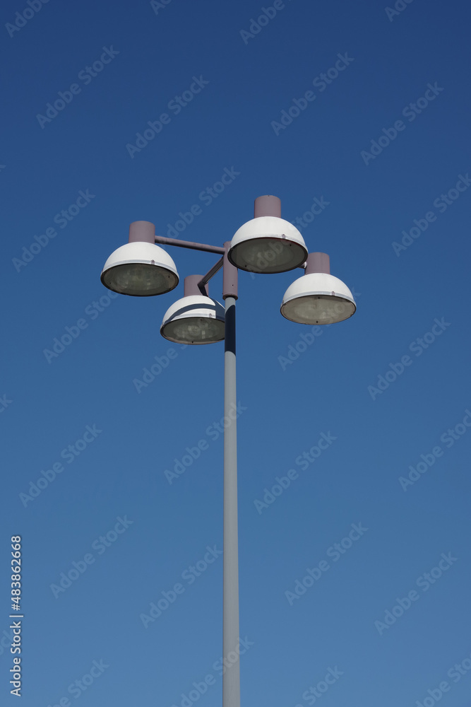 Streetlights on a high mast at a large shopping center parking lot Streetlights on a high mast at a large shopping center parking lot