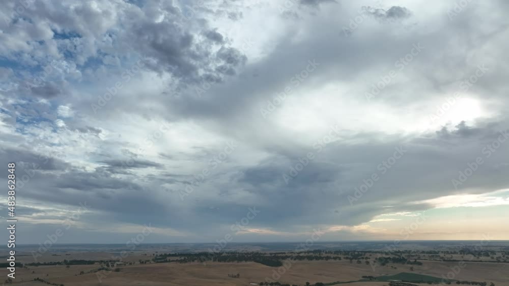 Storm clouds passing over a dry hilly landscape, over farming in Australia. Storm clouds passing over a dry hilly landscape, over farming in Australia.