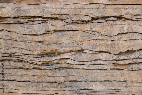 Natural stone wall, flagstone. Geological section of sedimentary rocks. Background for wallpaper, texture.