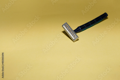 Used grungy rusty shaving razor isolated on yellow background. Close up. Copy space. © ozzuboy