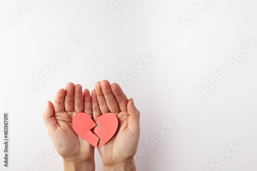 Foto Broken heart and hands on a white background