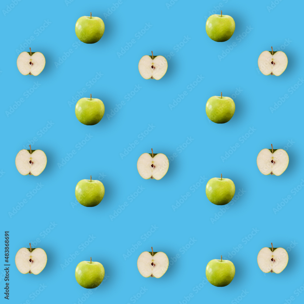 Colorful fruit pattern of fresh green apples on blue background with shadow. Top view. Flat lay. Pop art design, creative summer concept Colorful fruit pattern of fresh green apples on blue background with shadow. Top view. Flat lay. Pop art design, creative summer concept