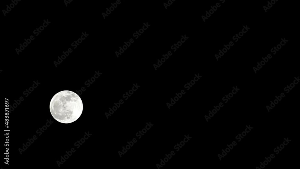 Moon Timelapse, Stock time lapse : Full moon rise in dark nature sky, night time. Full moon disk time lapse with moon light up in night dark black sky. High-quality free video footage or timelapse