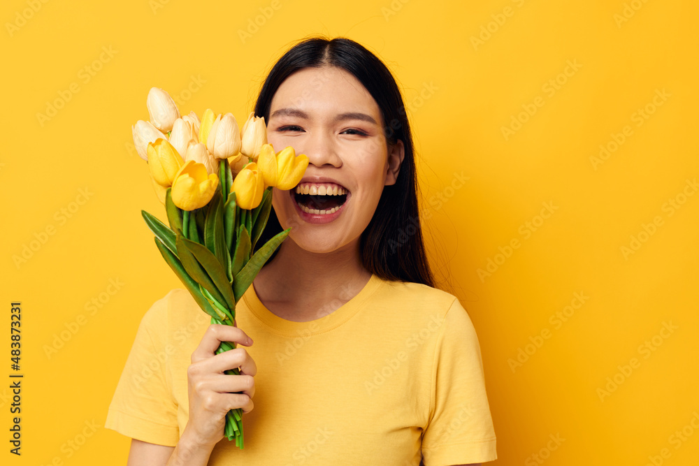 Charming young Asian woman with a bouquet of yellow flowers romance studio model unaltered Charming young Asian woman with a bouquet of yellow flowers romance studio model unaltered