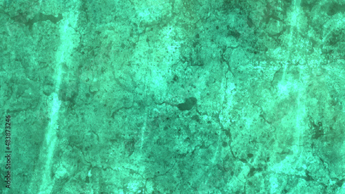 Old concrete wall sloppy painted green grungy backdrop. Trendy mint colored low contrast Concrete textured background with roughness and irregularities to your design.