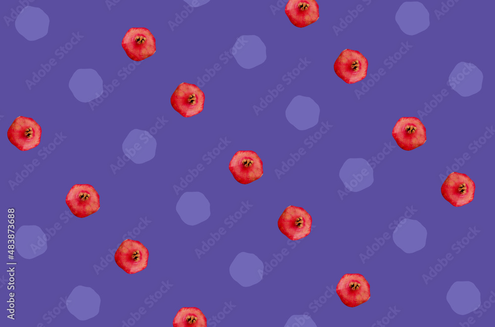 Colorful fruit pattern of fresh pomegranates on purple background. Top view. Flat lay. Pop art design Colorful fruit pattern of fresh pomegranates on purple background. Top view. Flat lay. Pop art design