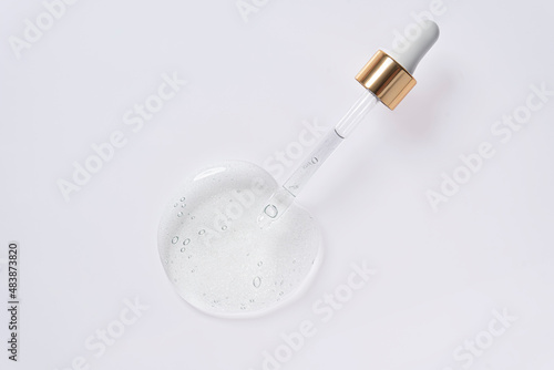 Liquid serum and dropper on a white background. photo