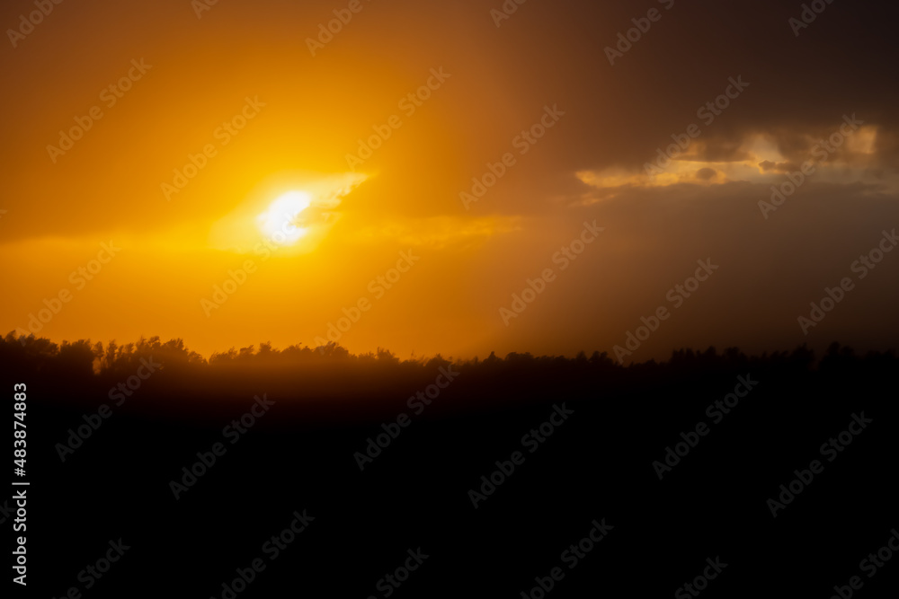 Beautiful sunset with golden orange clouds  background. Dramatic background.