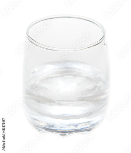 Shot glass with vodka isolated on white background.