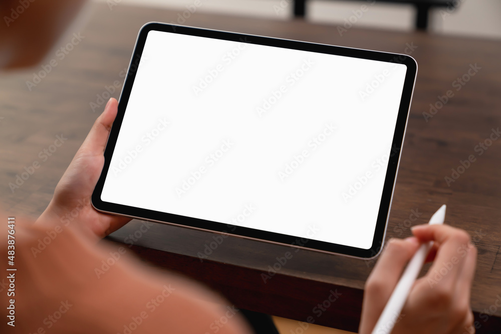 Mock up of woman hand holding digital tablet and touching blank screen. Mock up of woman hand holding digital tablet and touching blank screen.