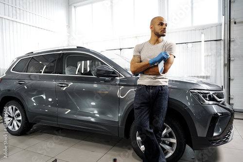 Portrait of African American man, car wash detailing service worker