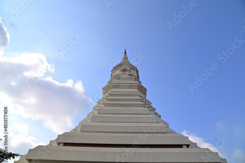 White Pagoda with blue sky and white cloud background at Buddha temple Thailand.