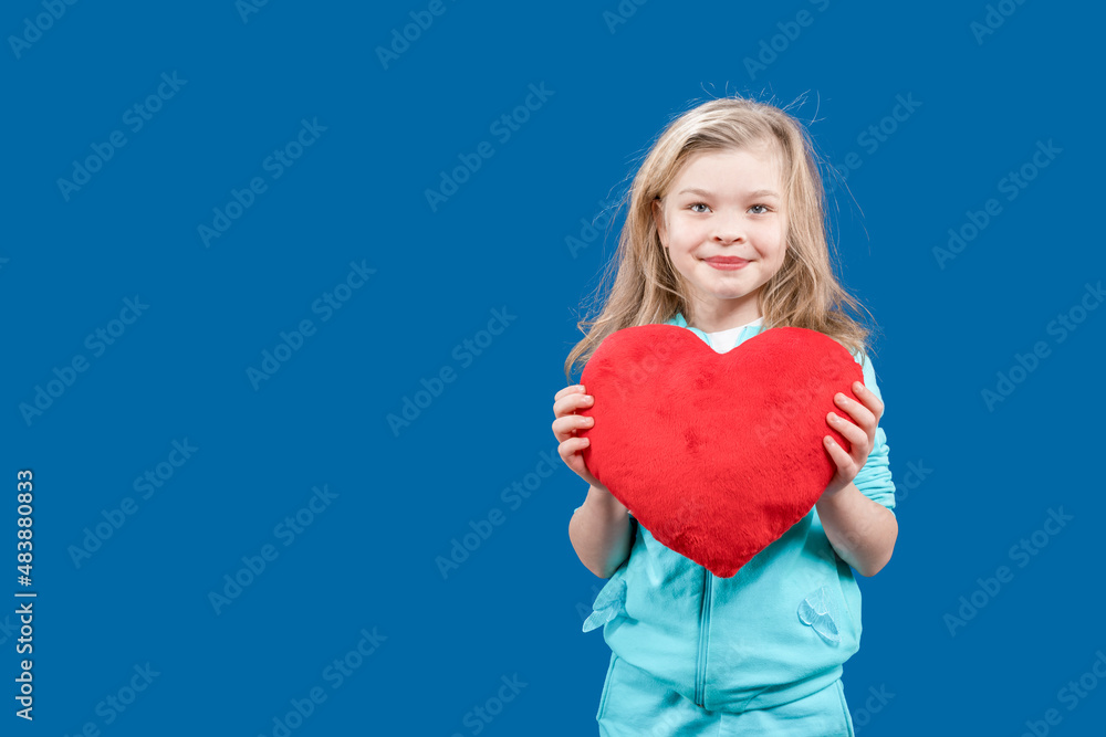 Valentine's day. Valentine's day. Postcard. Declaration of love. The girl is holding a large toy heart in her hands. The child congratulates the lovers on the holiday. Copy space. Valentine's day. Valentine's day. Postcard. Declaration of love. The girl is holding a large toy heart in her hands. The child congratulates the lovers on the holiday. Copy space.