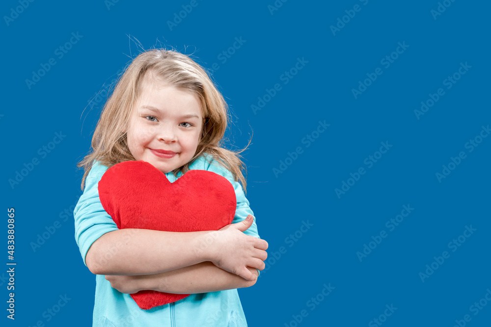 Valentine's day. The 14th of february. Valentine's day. Postcard. Declaration of love. Cute little girl hugs a big toy heart. The child congratulates all lovers on the holiday. Copy space. Valentine's day. The 14th of february. Valentine's day. Postcard. Declaration of love. Cute little girl hugs a big toy heart. The child congratulates all lovers on the holiday. Copy space.