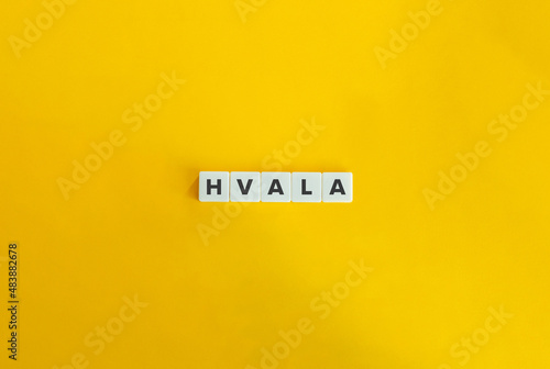 Hvala Word on Letter Tiles on Yellow Orange Background. Minimal aesthetics. photo