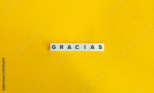 Gracias Word on Letter Tiles on Yellow Orange Background. Minimal aesthetics. photo