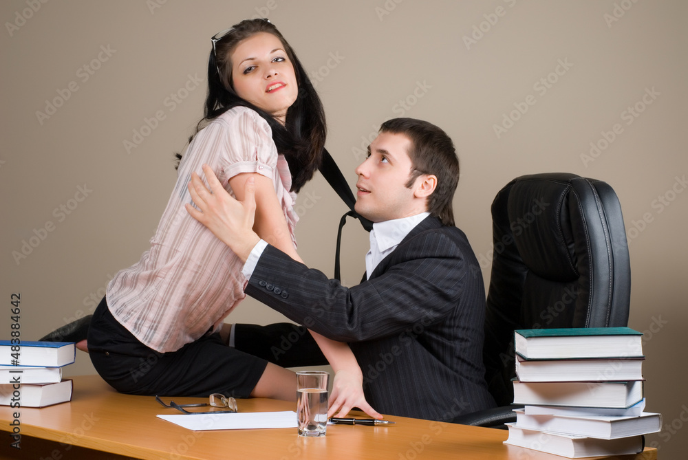 Businesswoman is seducing her boss at office Businesswoman is seducing her boss at office