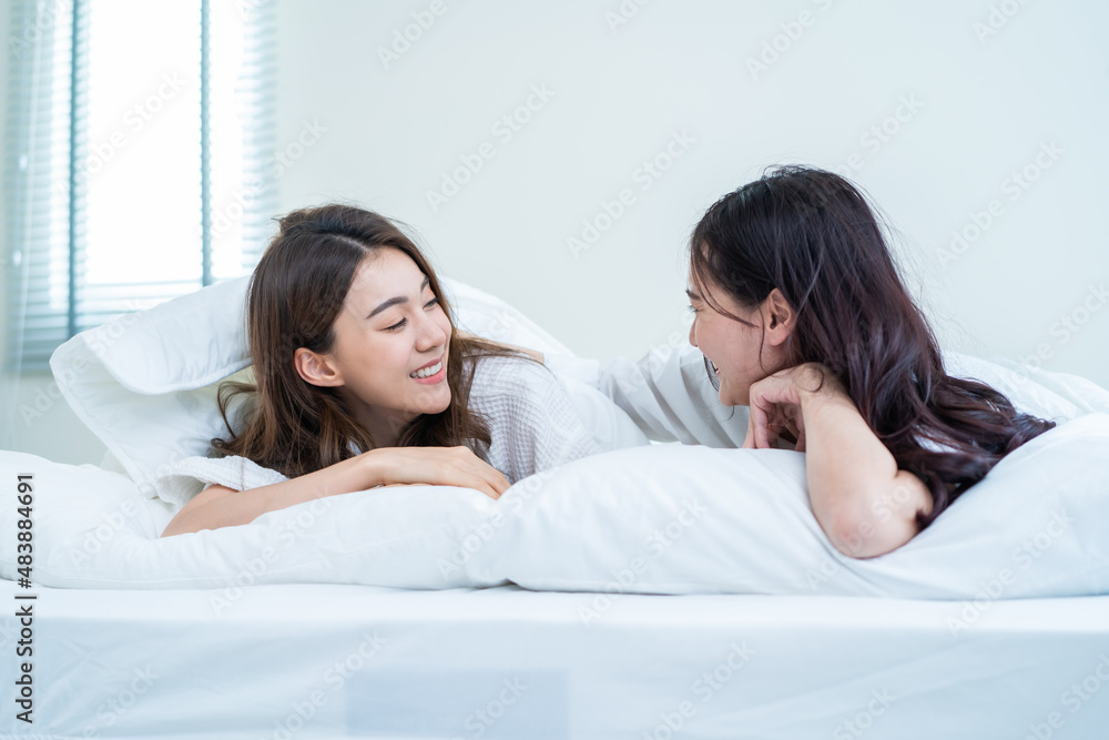 Asian beautiful lesbian couple lying on bed and looking at each other. Asian beautiful lesbian couple lying on bed and looking at each other.