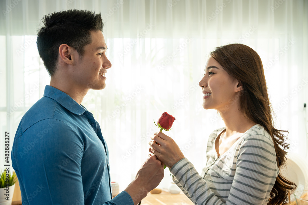 Asian young man surprise and give rose flower to beautiful girlfriend. Asian young man surprise and give rose flower to beautiful girlfriend.