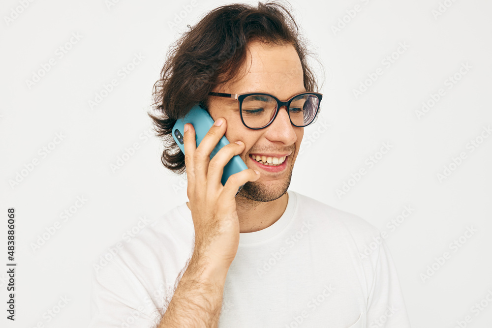 man in a white T-shirt communication by phone Lifestyle unaltered