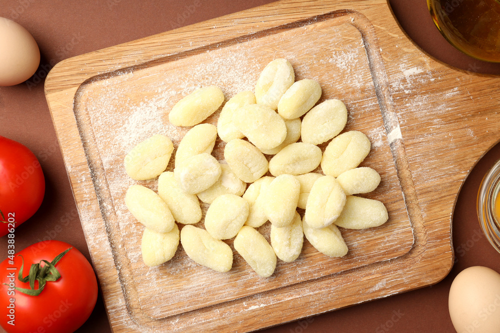 Concept of cooking with potato gnocchi on brown background Concept of cooking with potato gnocchi on brown background