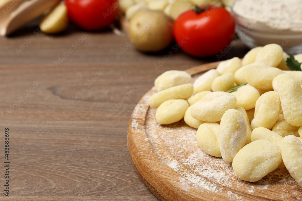Concept of cooking with potato gnocchi on wooden background Concept of cooking with potato gnocchi on wooden background