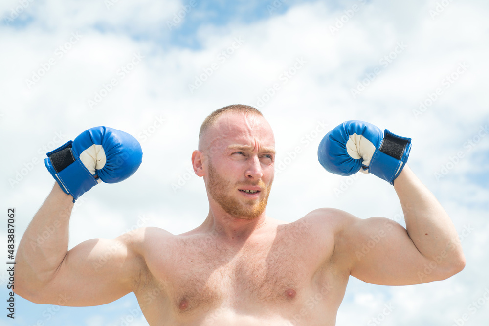 Strong muscular boxing man with muscular body and bare torso with boxing gloves. Strong muscular boxing man with muscular body and bare torso with boxing gloves.