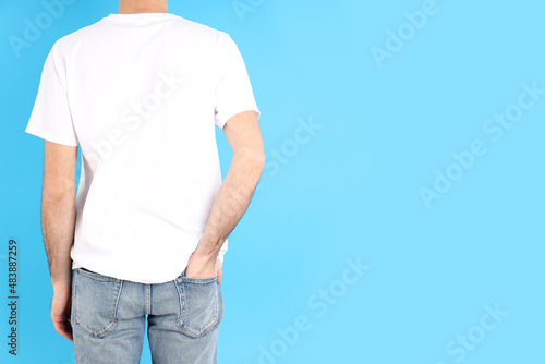 Man in blank white t-shirt on blue background