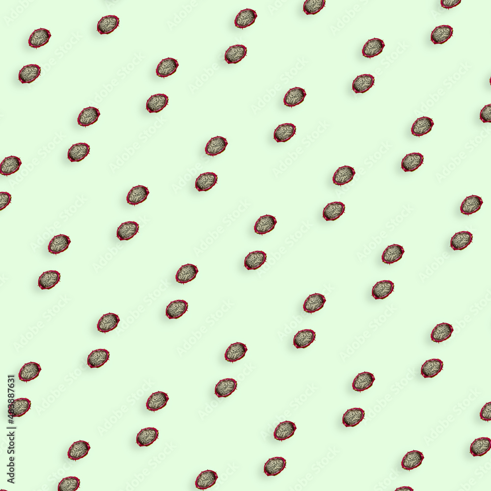 Colorful pattern of fresh dragon fruit on light green background. Pitaya. Top view. Flat lay. Pop art design Colorful pattern of fresh dragon fruit on light green background. Pitaya. Top view. Flat lay. Pop art design
