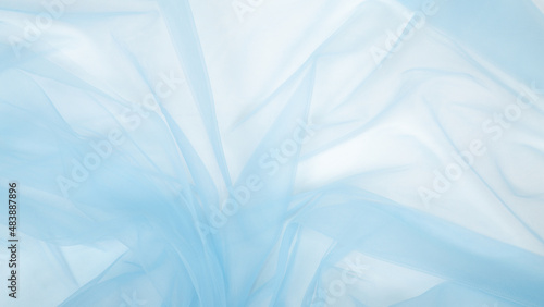 Beautiful delicate blue background mesh fluffy fabric. Banner. elegant pastel light blue tulle. Wedding. © Mariia