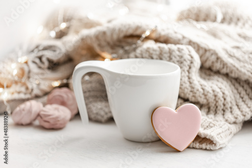 Composition for Valentine s Day with a cup and a heart-shaped gingerbread.